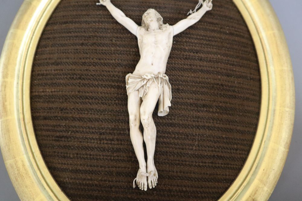 An ivory depiction of Christ, in gilt oval frame, carving 18cm
